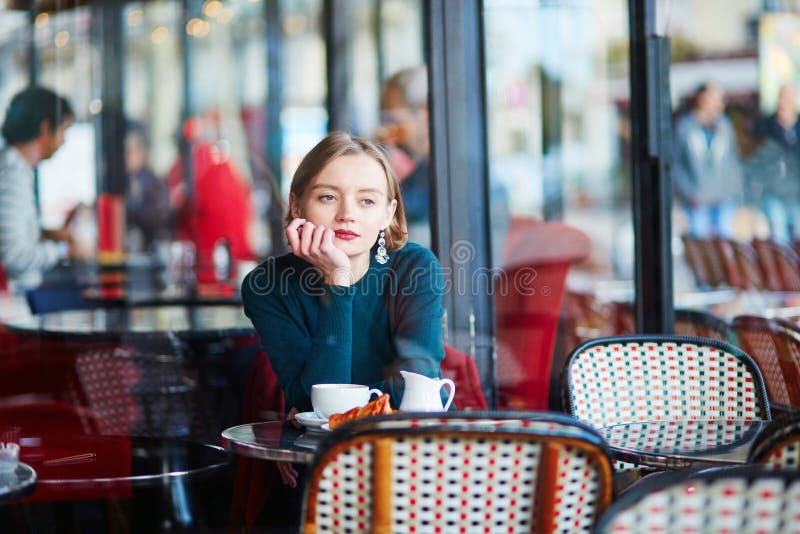 Young elegant woman drinking coffee in cafe in Paris, France royalty free stock image Young elegant woman drinking coffee in cafe in Paris, France royalty free stock image