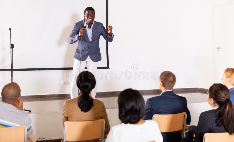 Young emotional male coach giving motivational speech royalty free stock photo