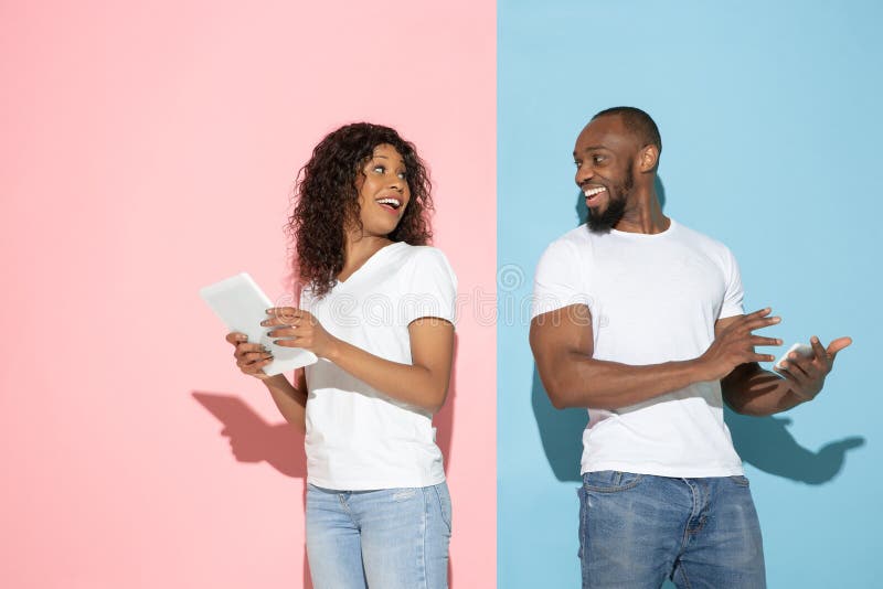 Young emotional man and woman on pink and blue background stock photography Young emotional man and woman on pink and blue background stock photography