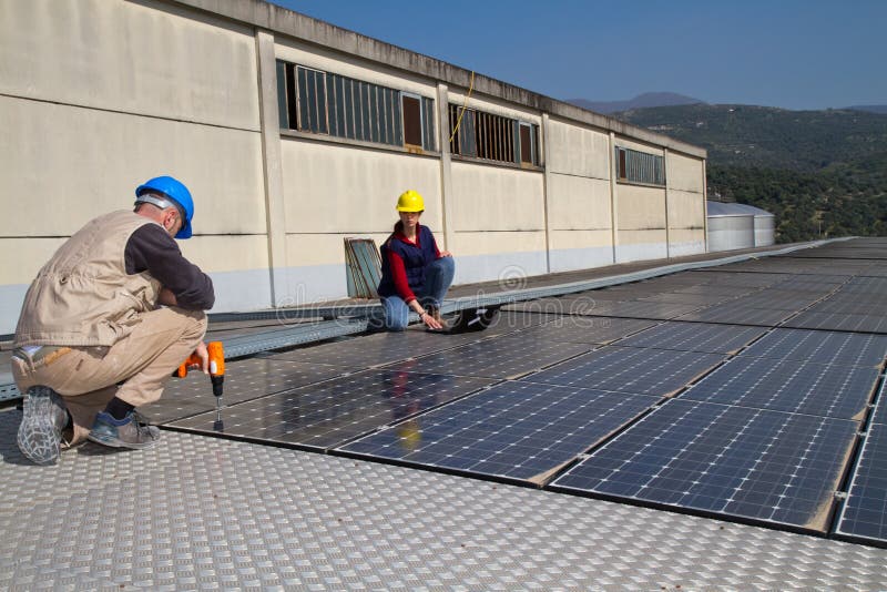 Young engineer girl and skilled worker on a roof stock photo Young engineer girl and skilled worker on a roof stock photo
