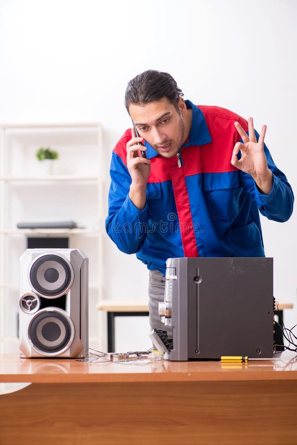 Young engineer repairing musical hi-fi system stock photo