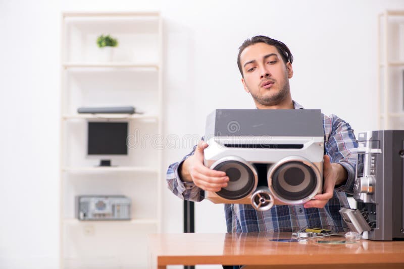 Young engineer repairing musical hi-fi system royalty free stock image