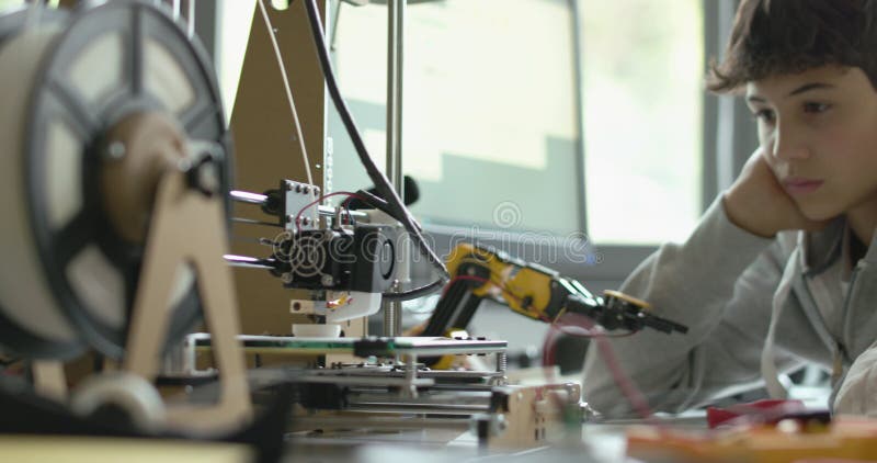 Students using a 3D printer in the lab stock video footage