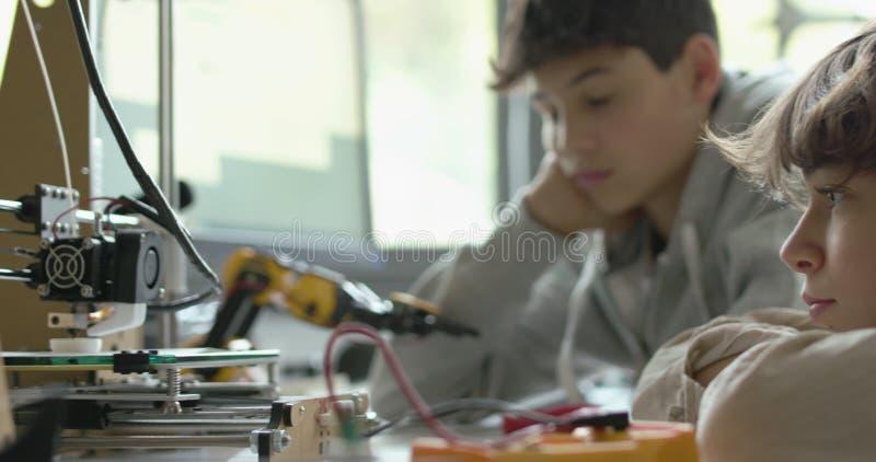 Students using a 3D printer in the lab stock footage
