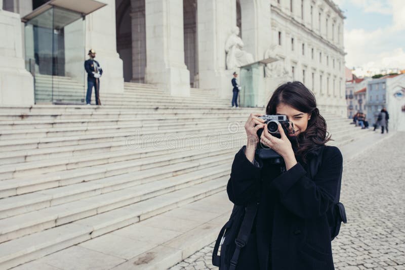 Young enthusiastic female photographer setting up lightweight carbon travel tripod for sunset/sunrise log exposure still shot stock photography Young enthusiastic female photographer setting up lightweight carbon travel tripod for sunset/sunrise log exposure still shot stock photography