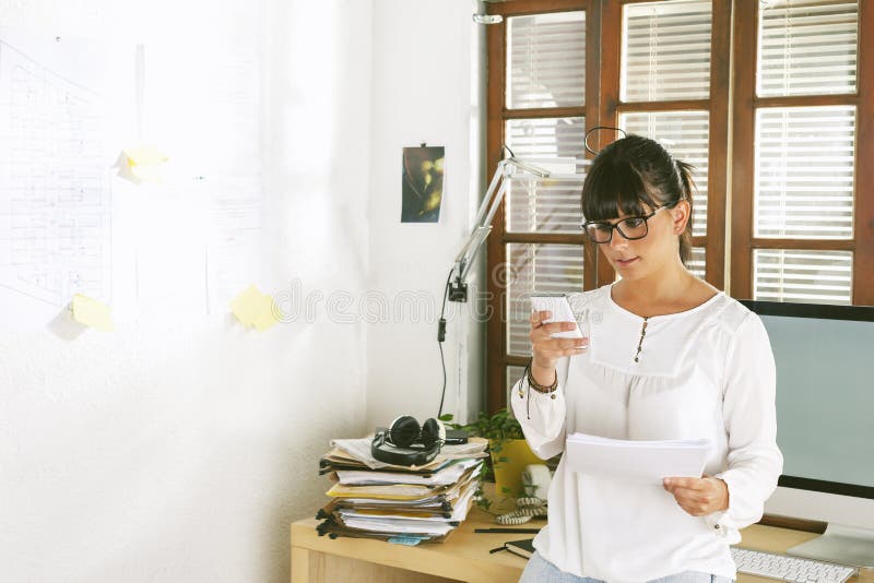 Young entrepreneur woman working on home office.