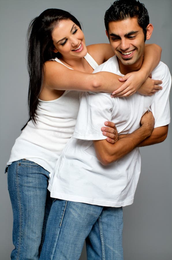 Young Ethnic Couple in Blue Jeans Stock Photo - Image of dark, cheerful: 16787966