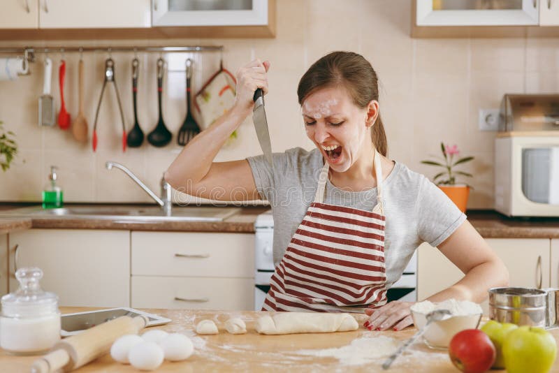 Young beautiful woman is cooking in the kitchen. royalty free stock images Young beautiful woman is cooking in the kitchen. royalty free stock images