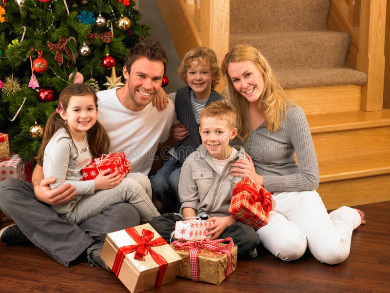 Young family at home exchanging gifts