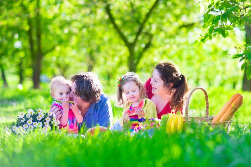 Young family with kids having picnic outdoors royalty free stock photos Young family with kids having picnic outdoors royalty free stock photos