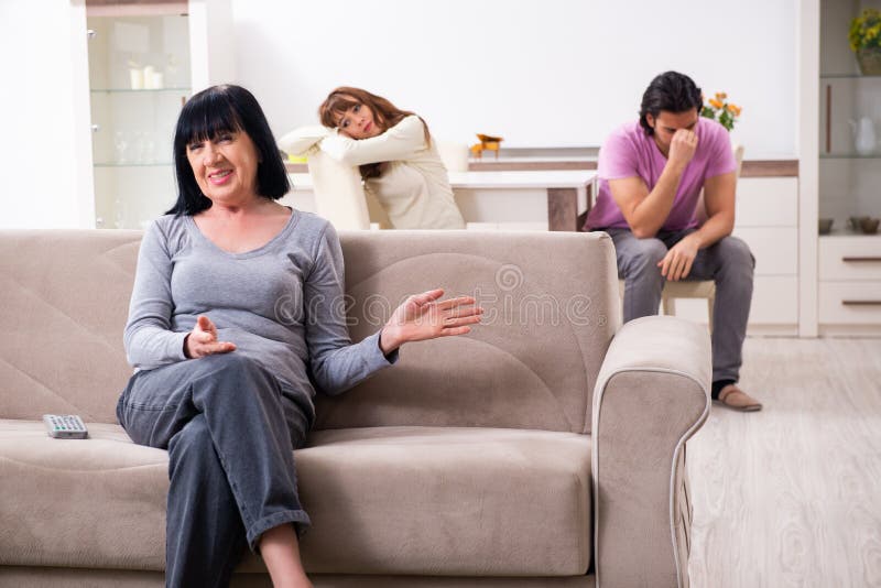 Young family and mother-in-law in family issues concept royalty free stock photography