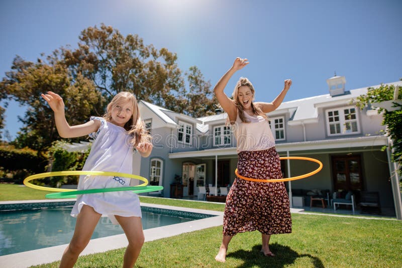 Young family playing with hula hoop