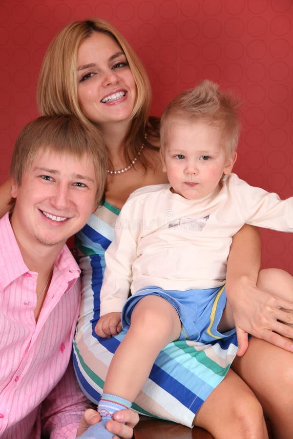 Young family in red room