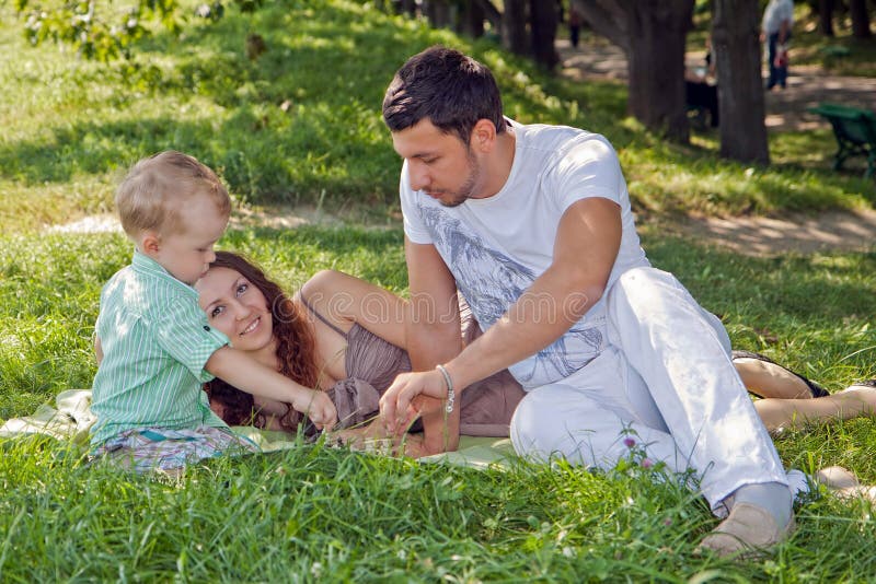 Young family relaxing in park