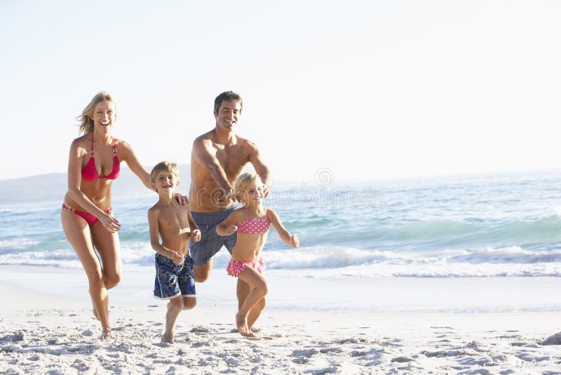 Young Family Running Along Beach on Holiday