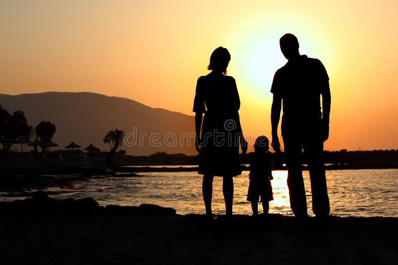 Young family at sunset royalty free stock photo
