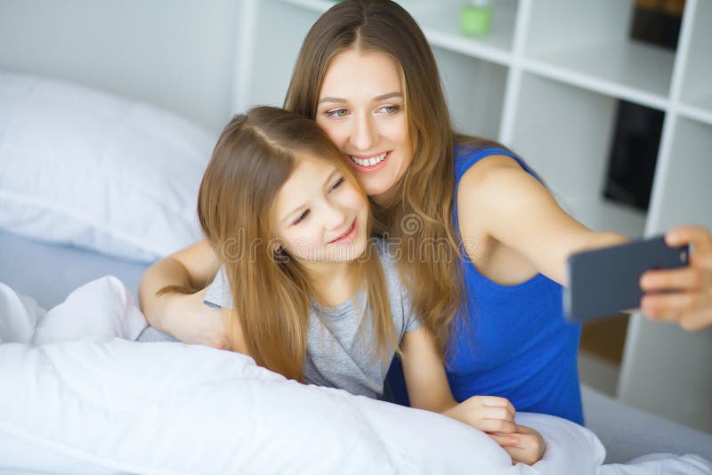 Young Family Taking Selfie in Bed Stock Image - Image of portrait ...