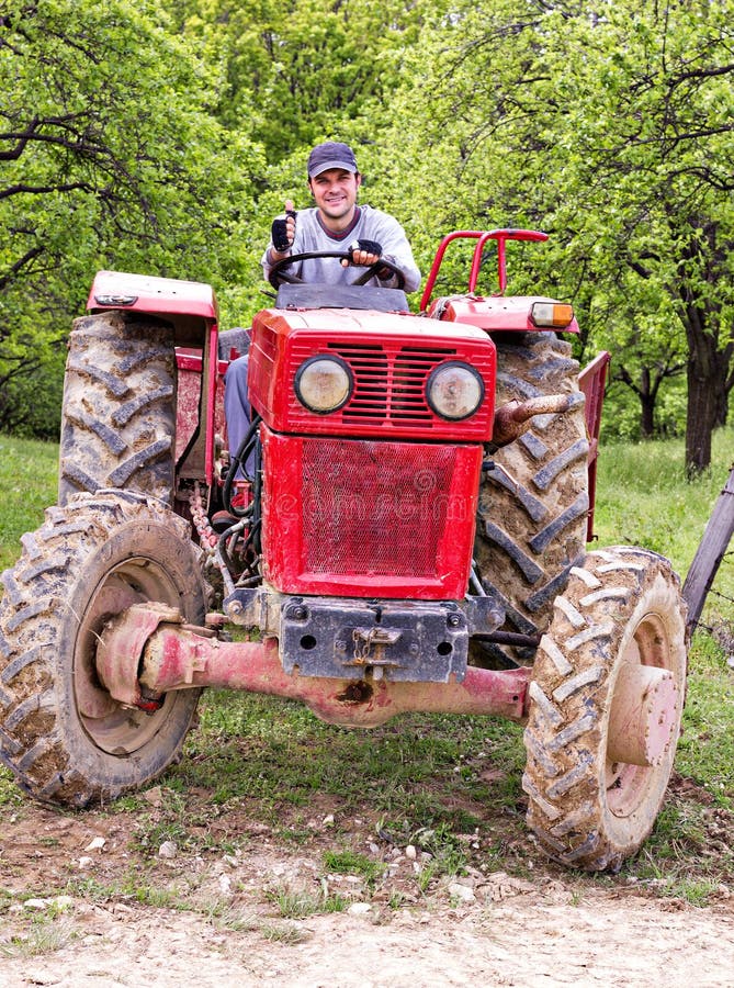 Young farmer driving his tractor royalty free stock images