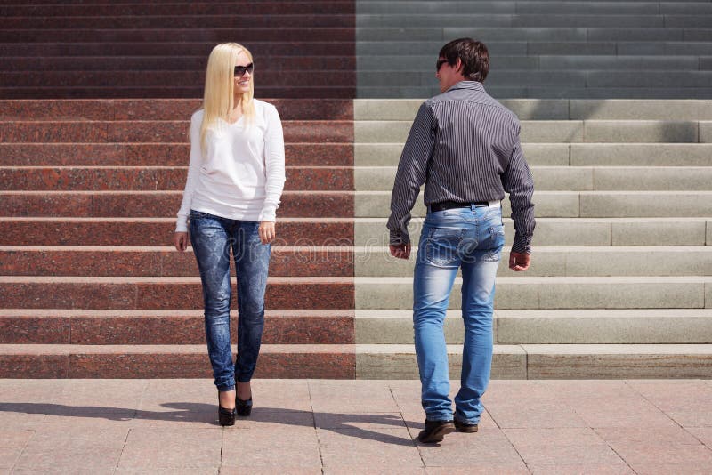 Young fashion couple flirting on city street