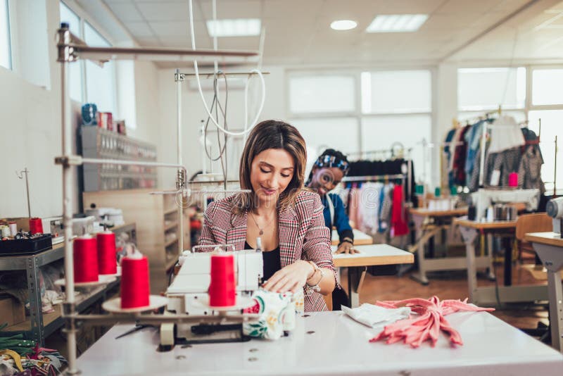 Fashion Designer Using Sewing Machine in Her Stock Photo