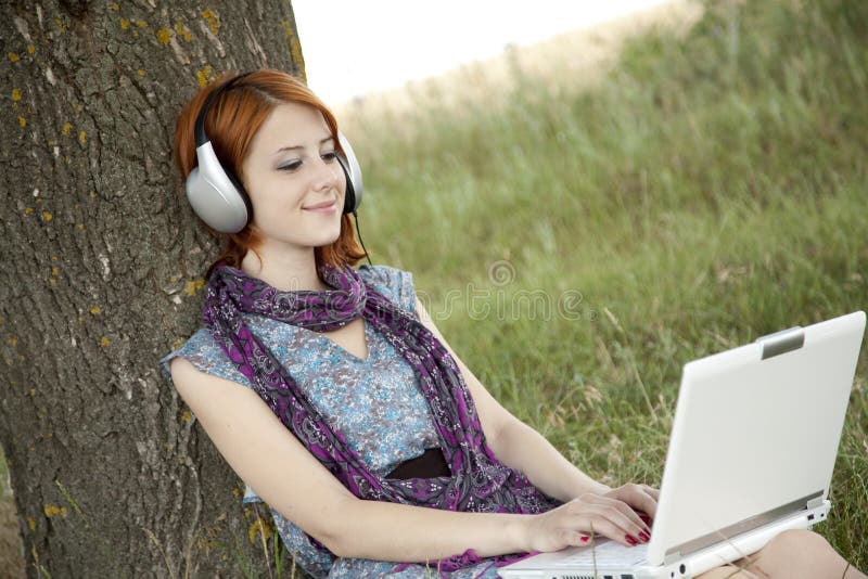 Young fashion girl with notebook and headphones