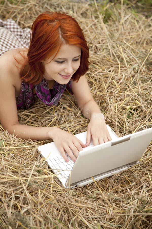 Young fashion girl with notebook lying at field