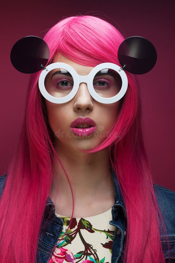 Young fashion girl with pink hair and big sunglasses