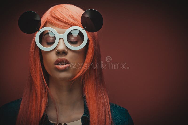 Young fashion girl with pink hair and big sunglasses