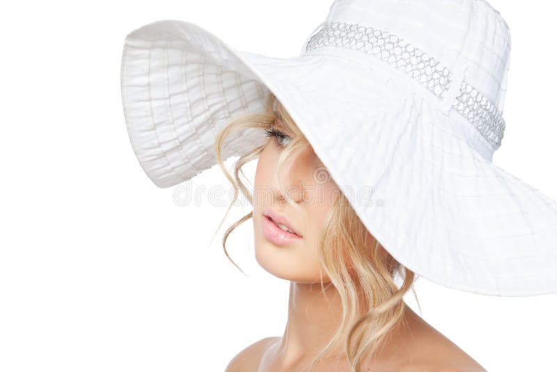 Young fashion woman in a big hat posing in studio