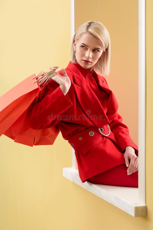 Young Fashionable Woman in Red Clothing with Red Shopping Bags Sitting ...