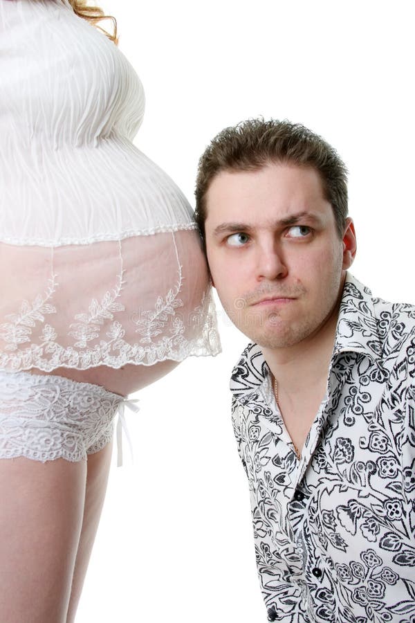 Young father listening to his unborn child royalty free stock image Young father listening to his unborn child royalty free stock image