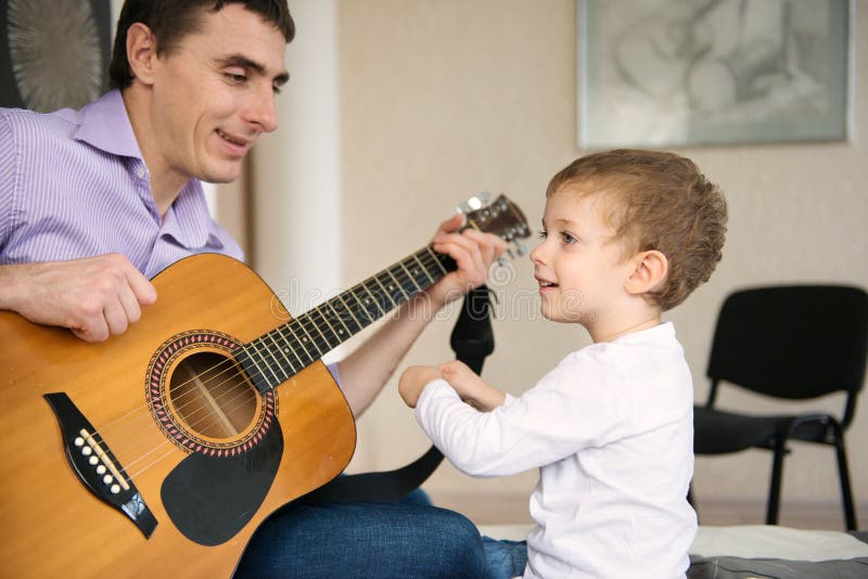 Download Young Father And Little Son Playing Guitar Stock Photo - Image of parenthood, education: 35515182