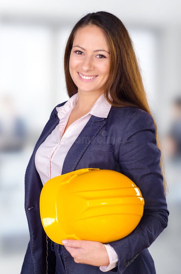 Young female architect posing with hard hat