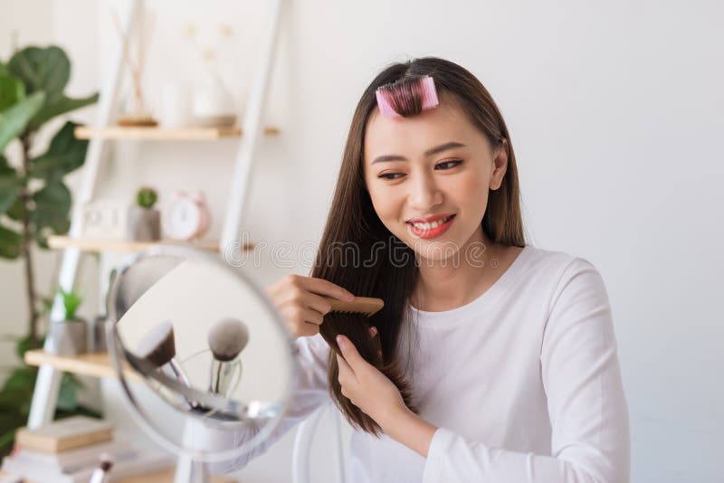 Young female blogger with combs recording video at home royalty free stock photos Young female blogger with combs recording video at home royalty free stock photos