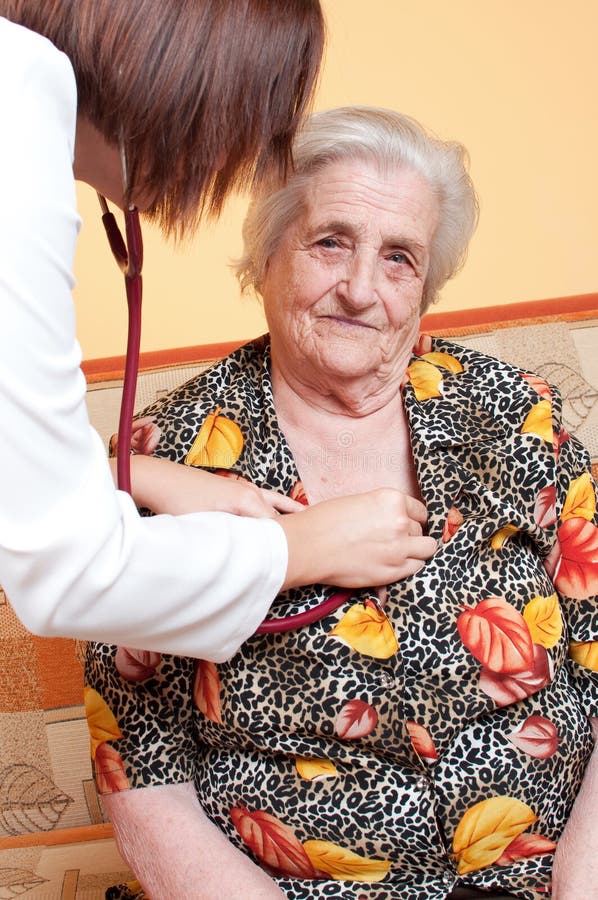 Young female doctor checking patient heart beat