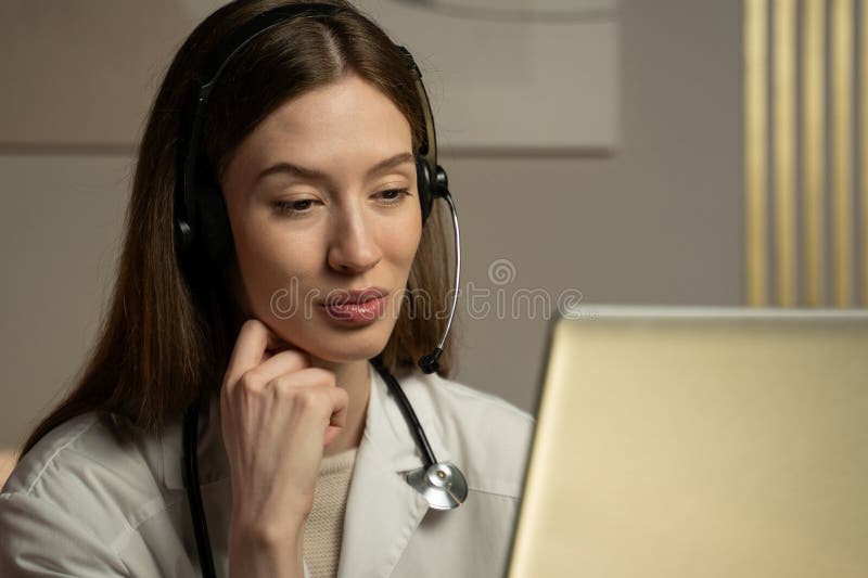 Tinere doctor se angajează în comunicații video cu un pacient stock image