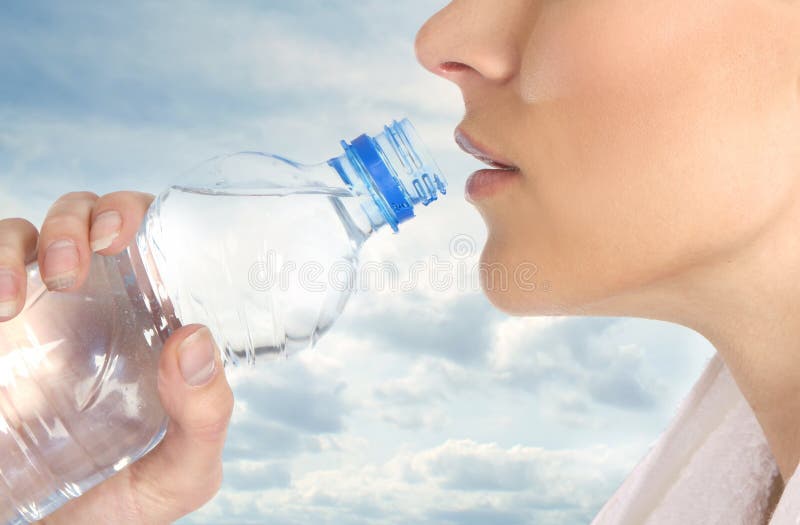 A young female is drinking refreshing water