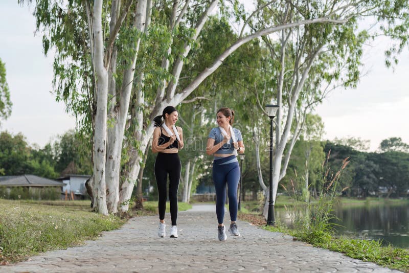 Young Female Friends Exercising Together in a Park, Enjoying Outdoor Fitness and Healthy Lifestyle royalty free stock image