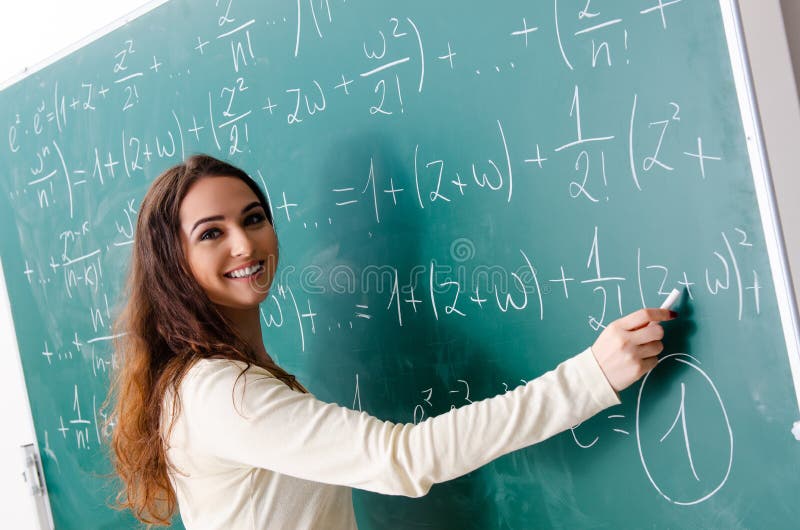 The young female math teacher in front of chalkboard