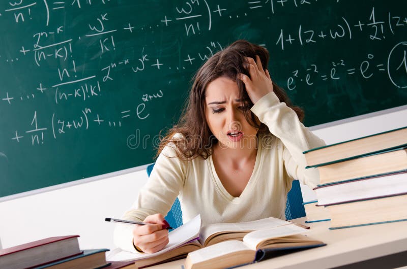Young female math teacher in front of chalkboard royalty free stock images Young female math teacher in front of chalkboard royalty free stock images