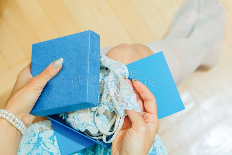 Young female opens a gift box with lingerie royalty free stock image Young female opens a gift box with lingerie royalty free stock image