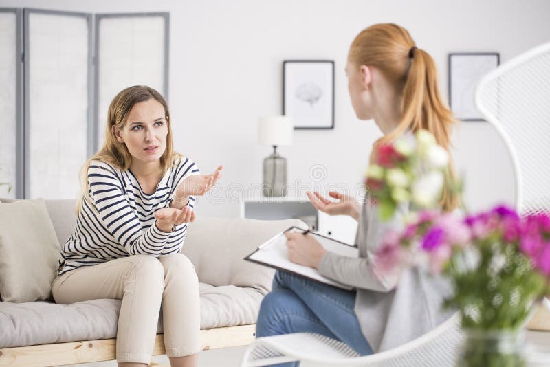 Joven una mujer discurso terapeuta en oficina acerca de problemas a preocupaciones, consultorio psicología.