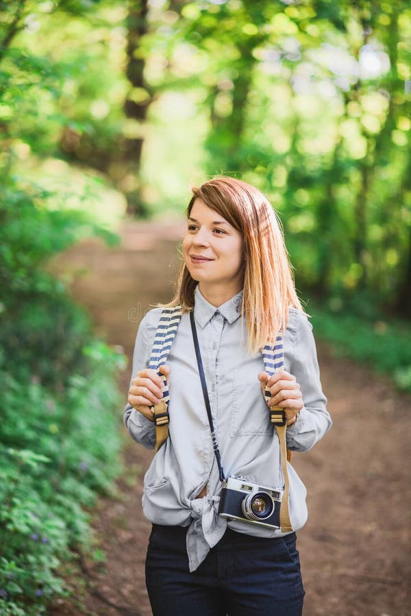 Young female photographer in the forest. Female traveler standing stock images, royalty-free photos and pictures