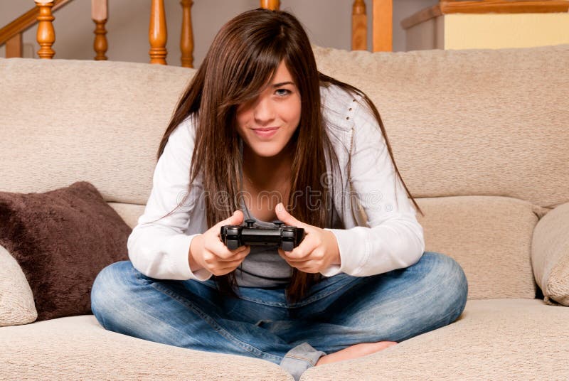 Young female playing video-games home