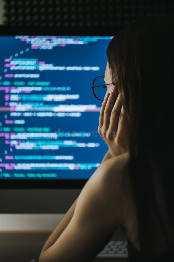 Young female programmer writes program code on a computer. royalty free stock images