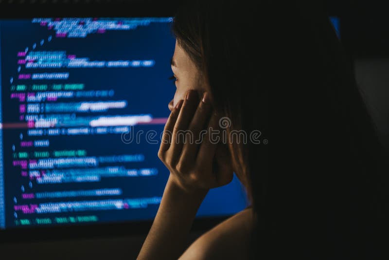 Young female programmer writes program code on a computer. royalty free stock images