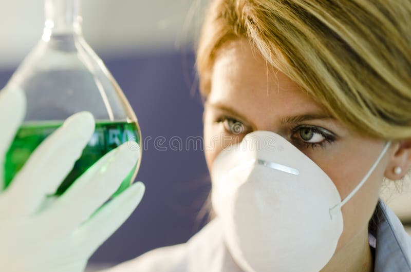 Young female researcher working with beaker