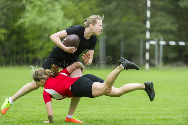 The young female rugby player on green backround