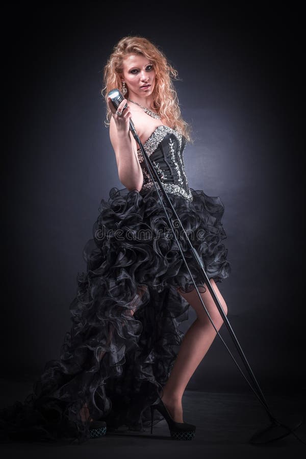 Young female singer performing a musical composition royalty free stock photo Young female singer performing a musical composition royalty free stock photo
