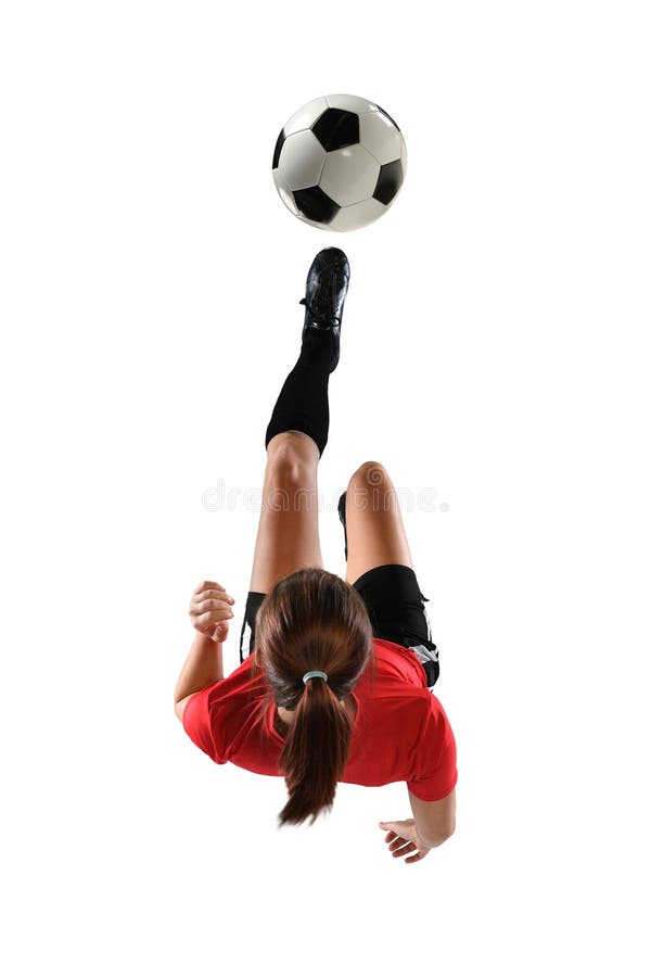 Young Female Soccer Player kicking the ball in mid-air isolated over white background